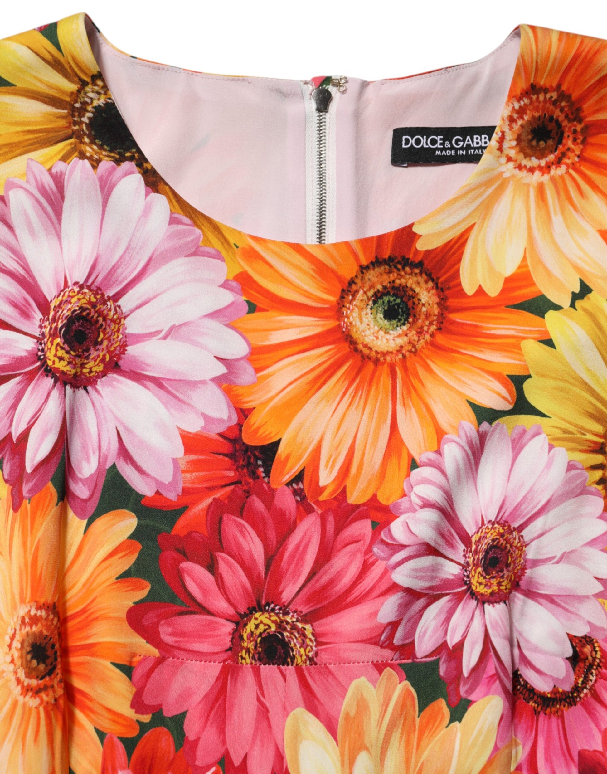 A midi dress with a floral print featuring pink, yellow and orange flowers