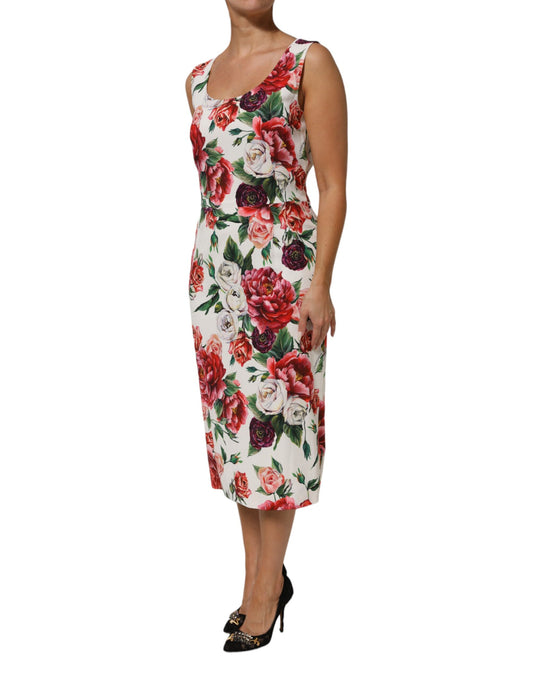 A woman wearing a floral print dress with short sleeves and a sheath silhouette