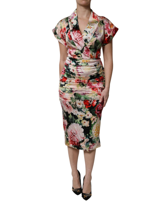 A woman wearing a multicolored floral sheath dress with short sleeves
