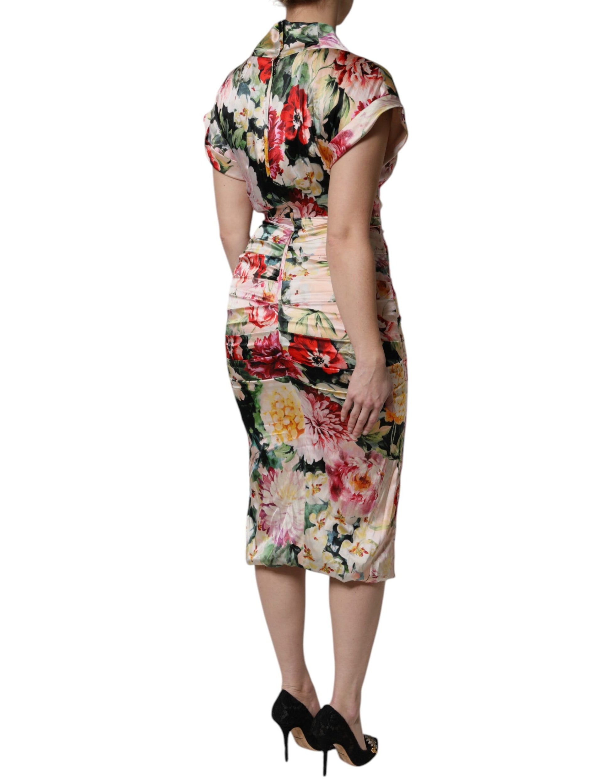 A woman wearing a floral print midi dress with short sleeves