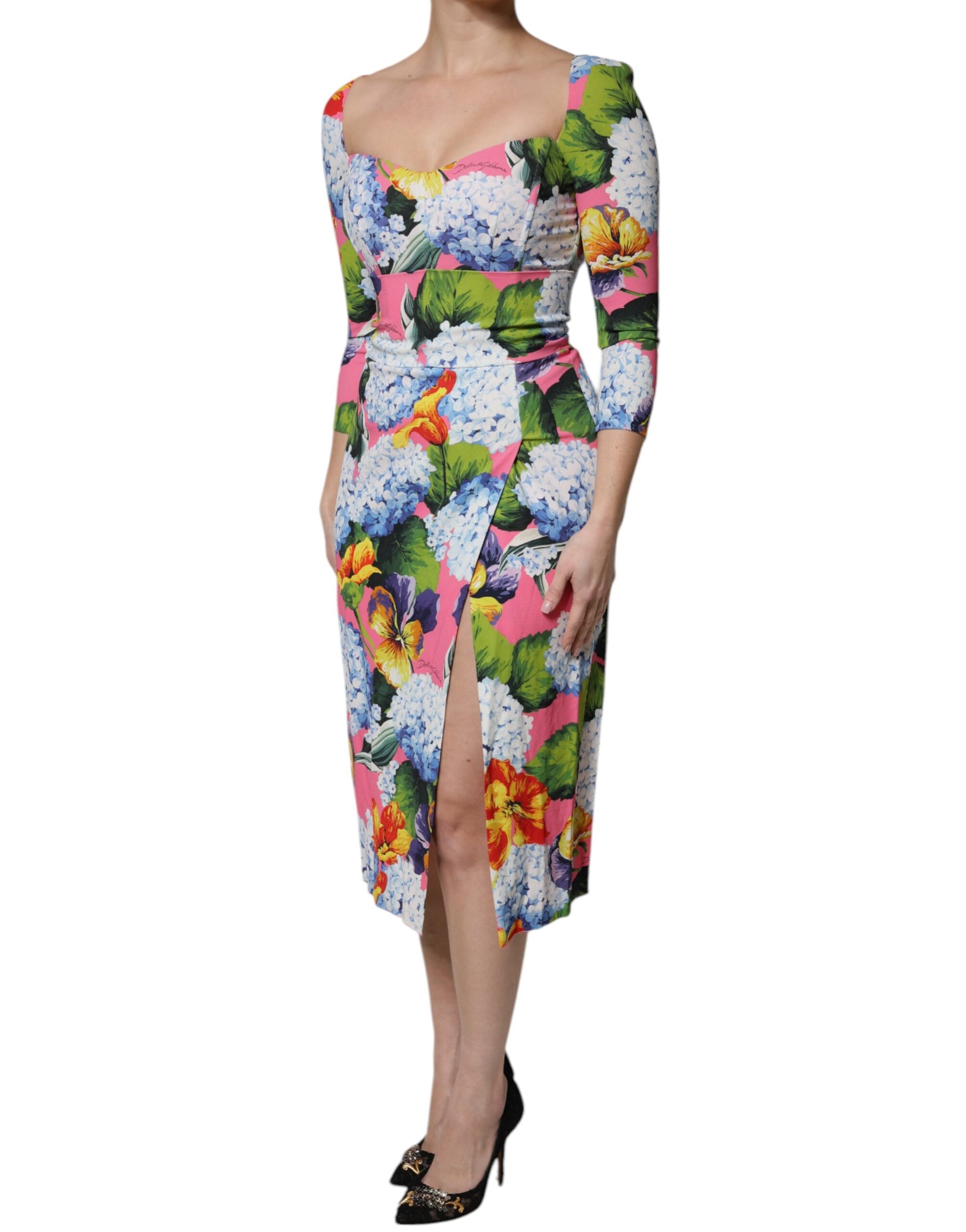 A colorful midi dress with floral print and side slits, designed by Dolce & Gabbana