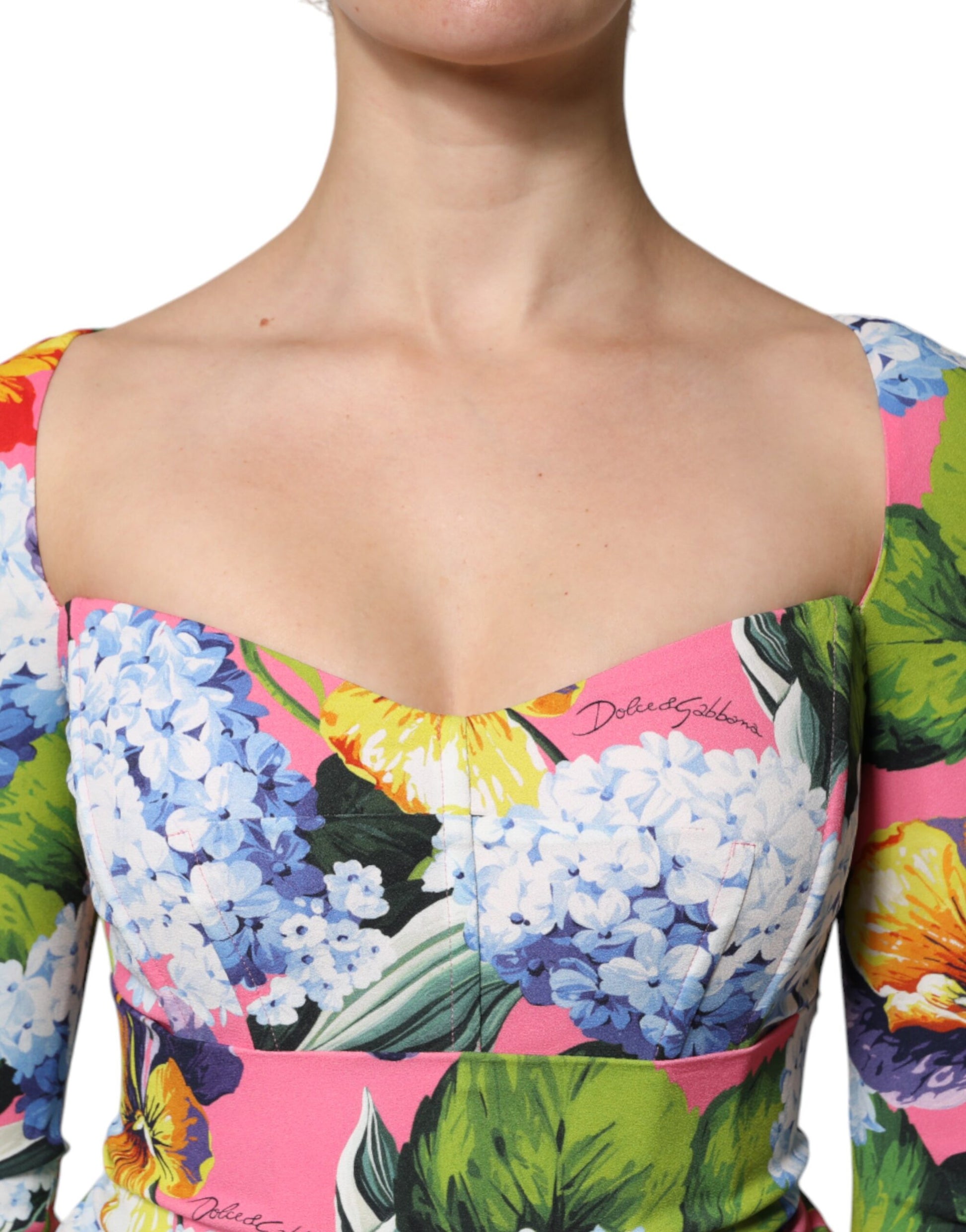 A colorful floral midi dress with side slits, sleeveless design and a V-neckline