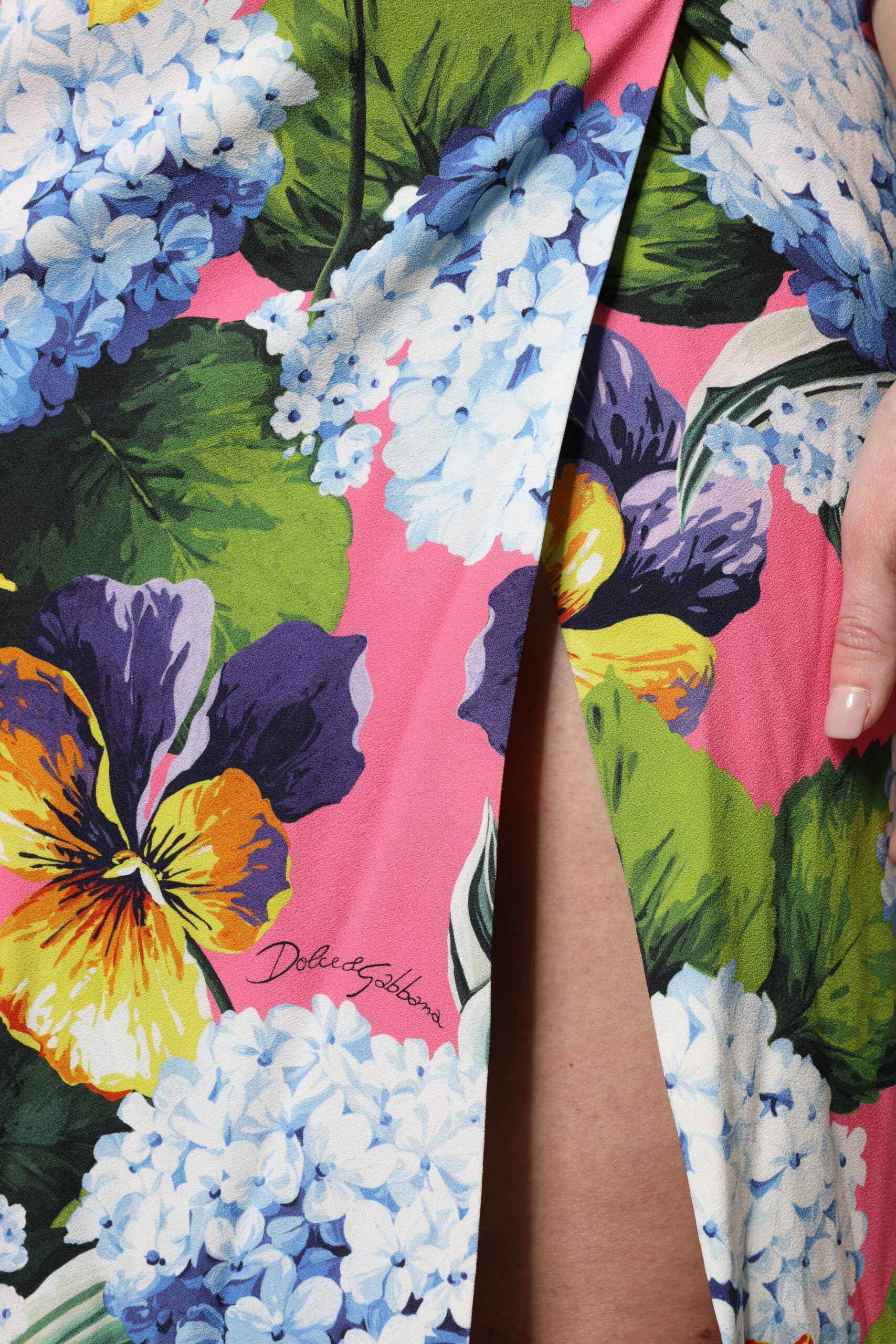 A colorful floral midi dress with side slits and a vibrant pattern