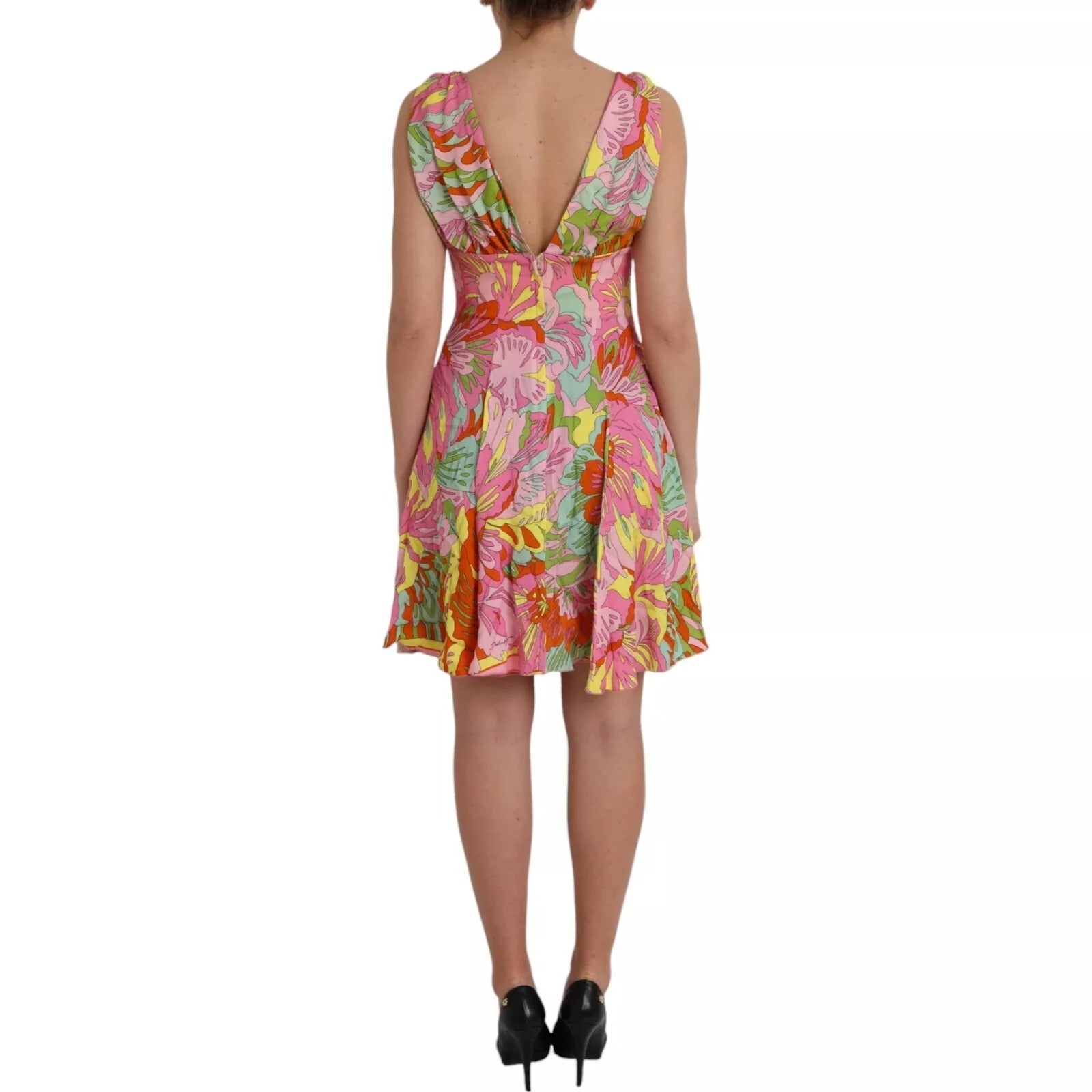 A woman wearing a colorful floral dress with a flared skirt