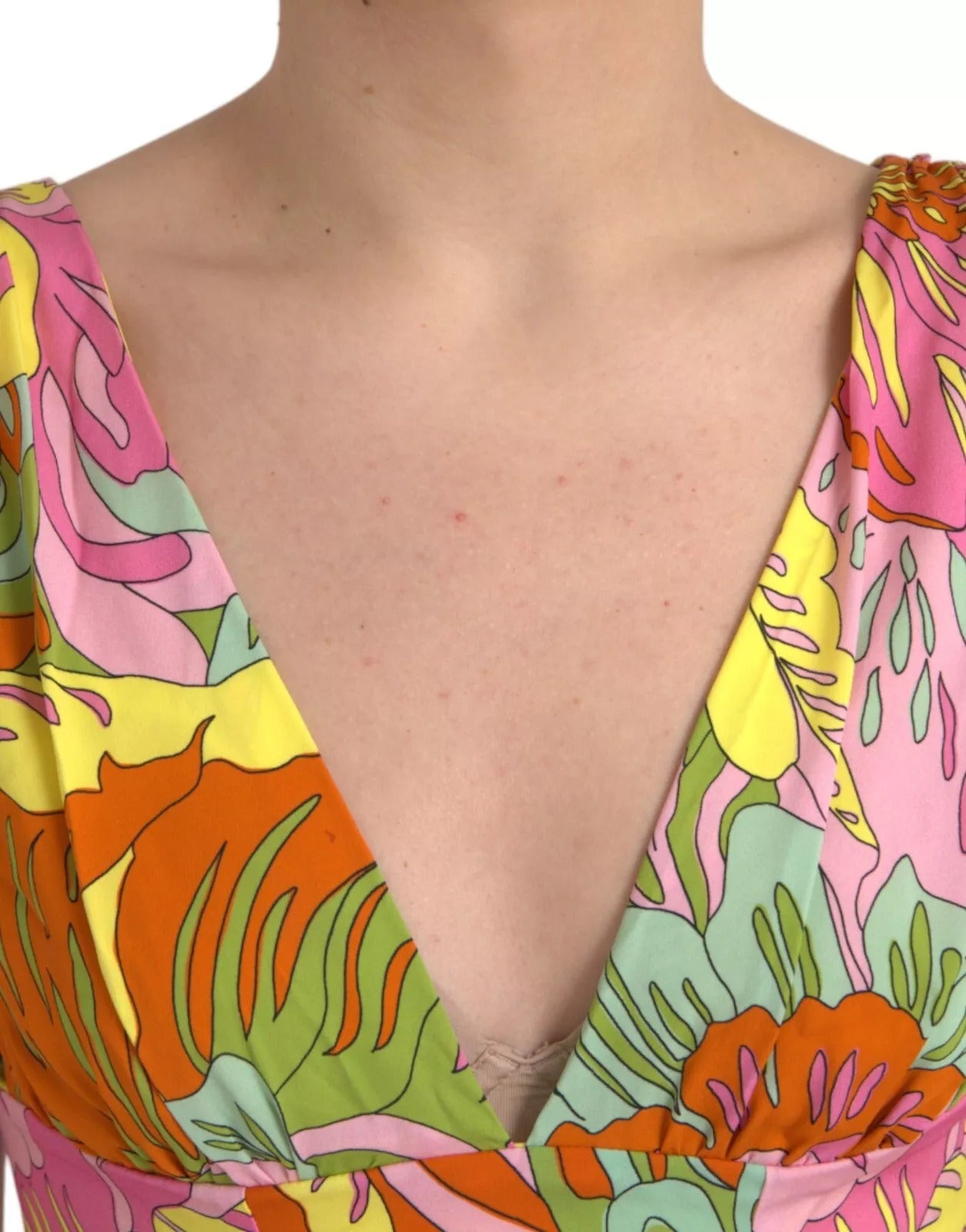 A woman wearing a colorful floral flared mini dress with a deep V neckline