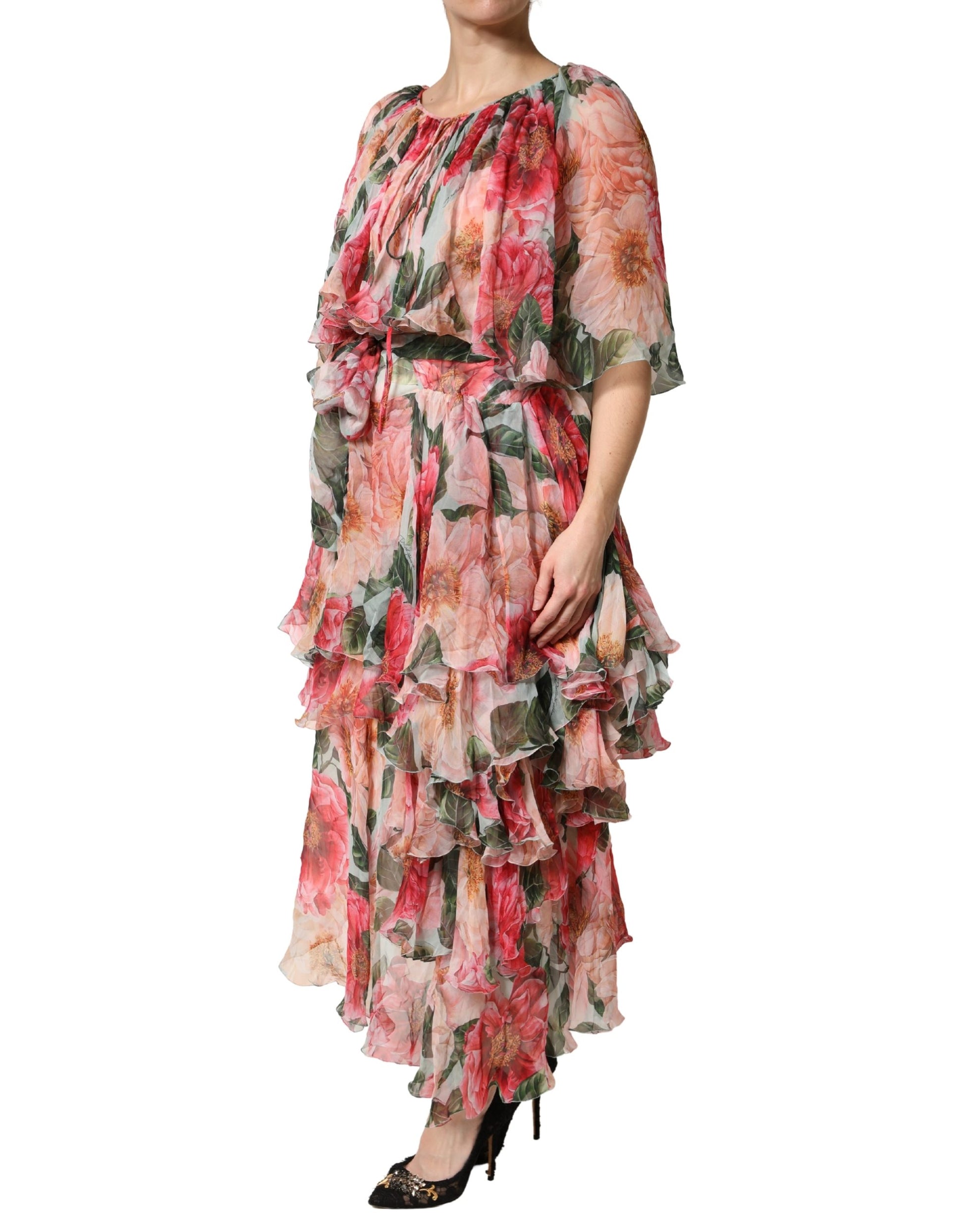 A woman wearing a long, layered maxi dress with floral print