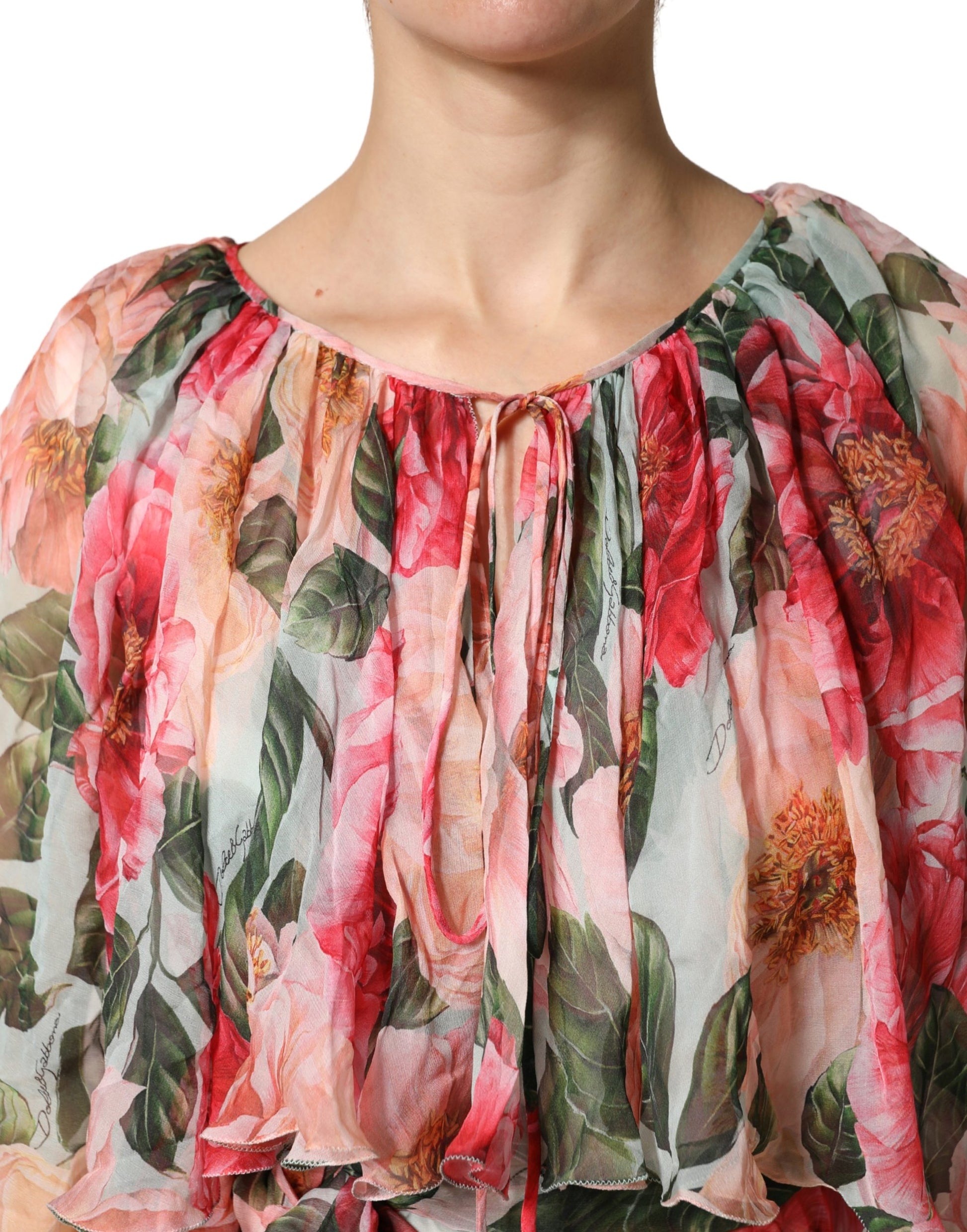A woman wearing a multicolored floral silk layered maxi dress