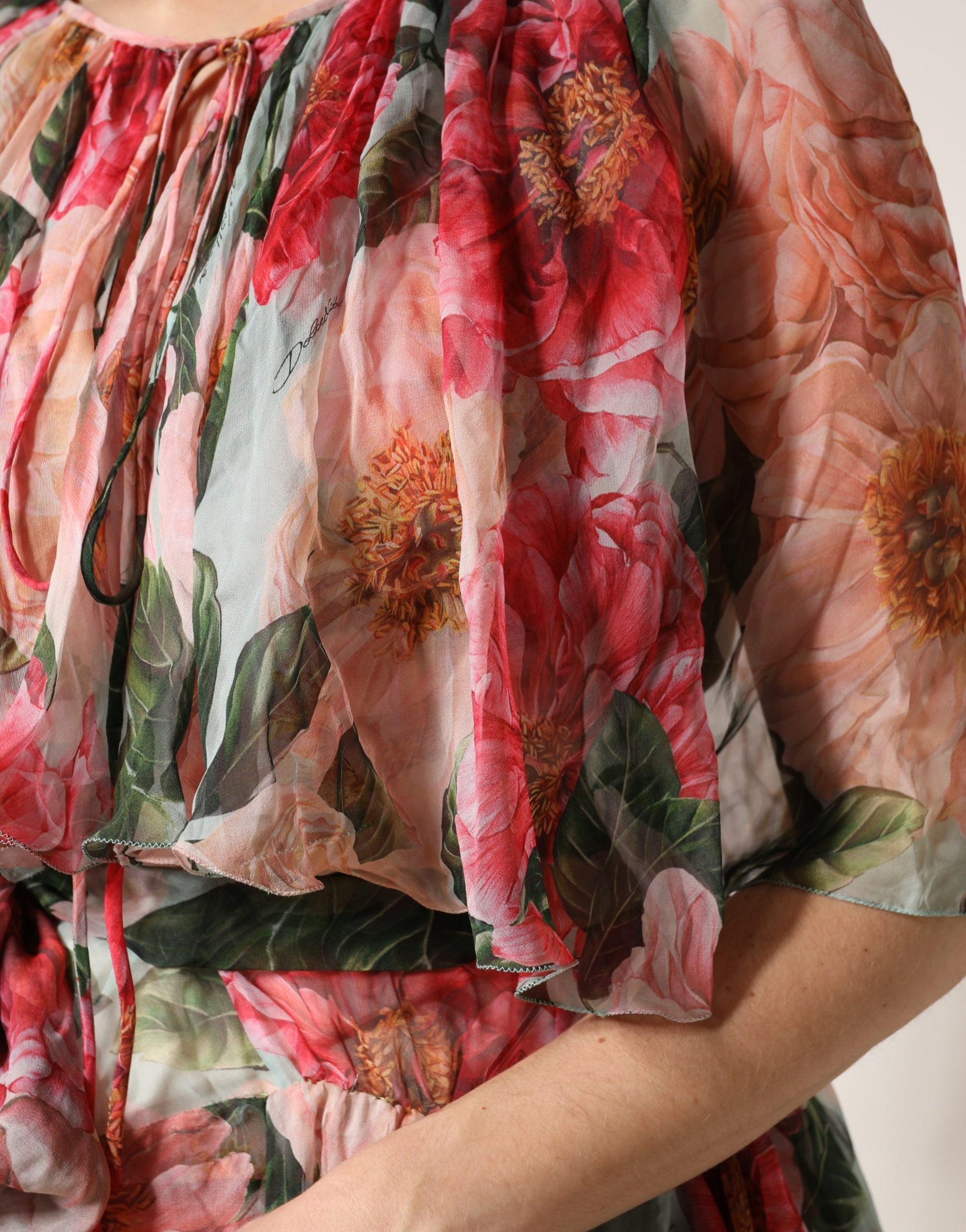 A woman wearing a multicolored floral silk layered maxi dress