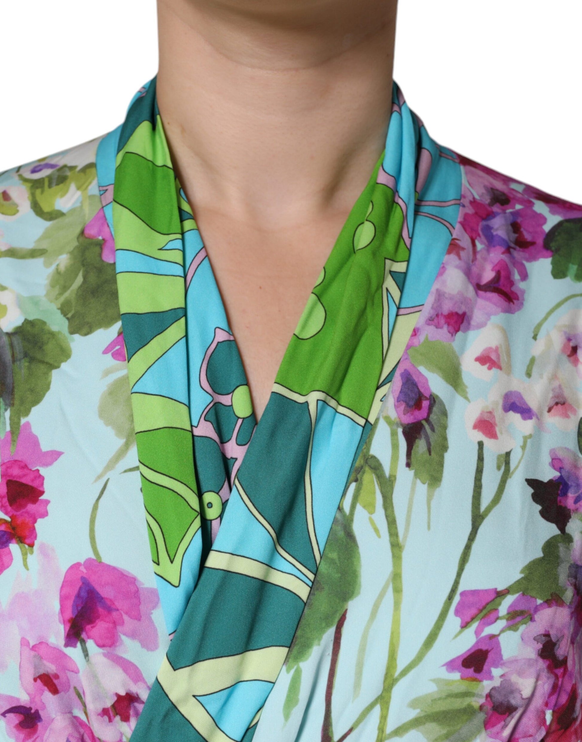 A woman wearing a colorful floral print dress with a wrap style and stretchy fabric