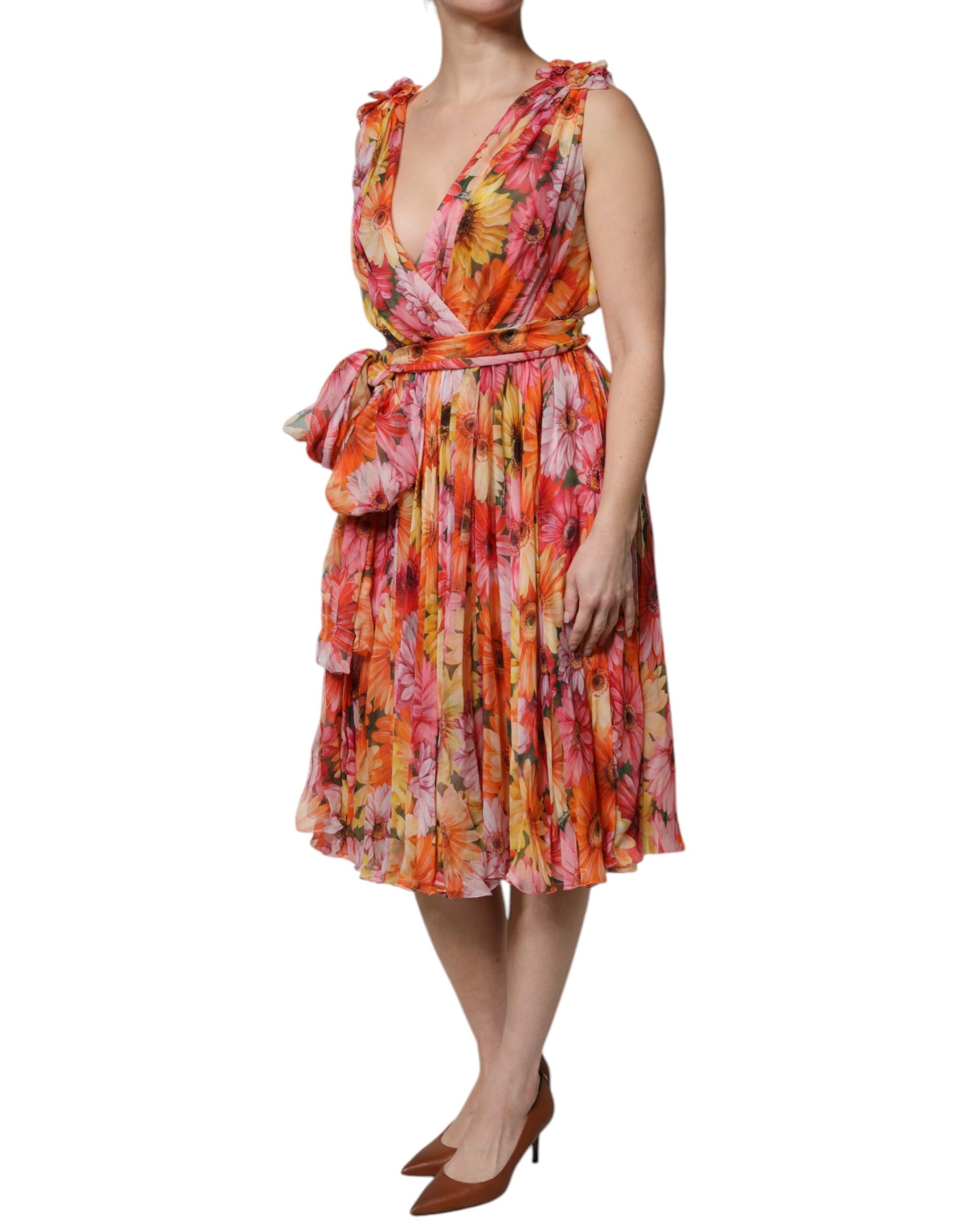 A woman wearing a multicolored floral silk chiffon dress with a V-neck