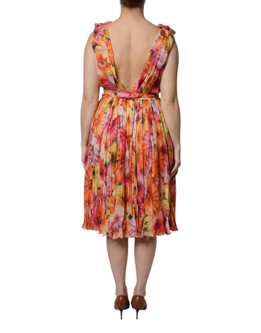 A woman wearing a multicolored floral silk chiffon dress with a V-neck