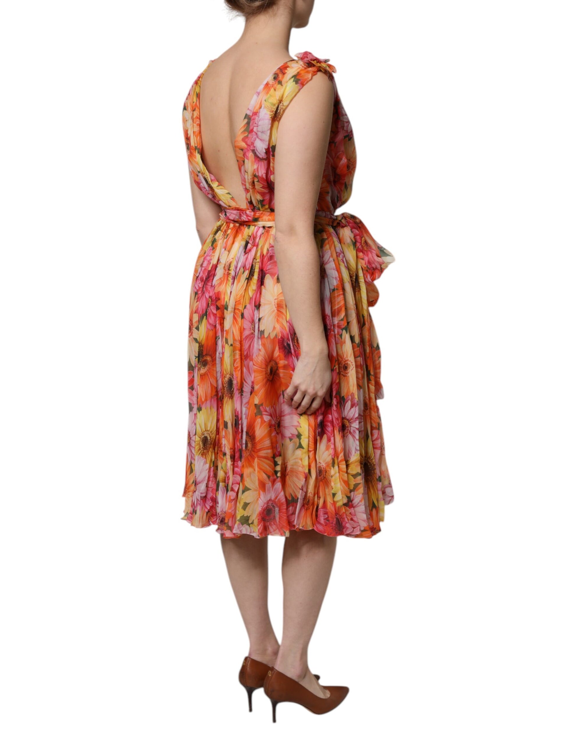 A woman wearing a multicolored floral silk chiffon dress with a V-neck