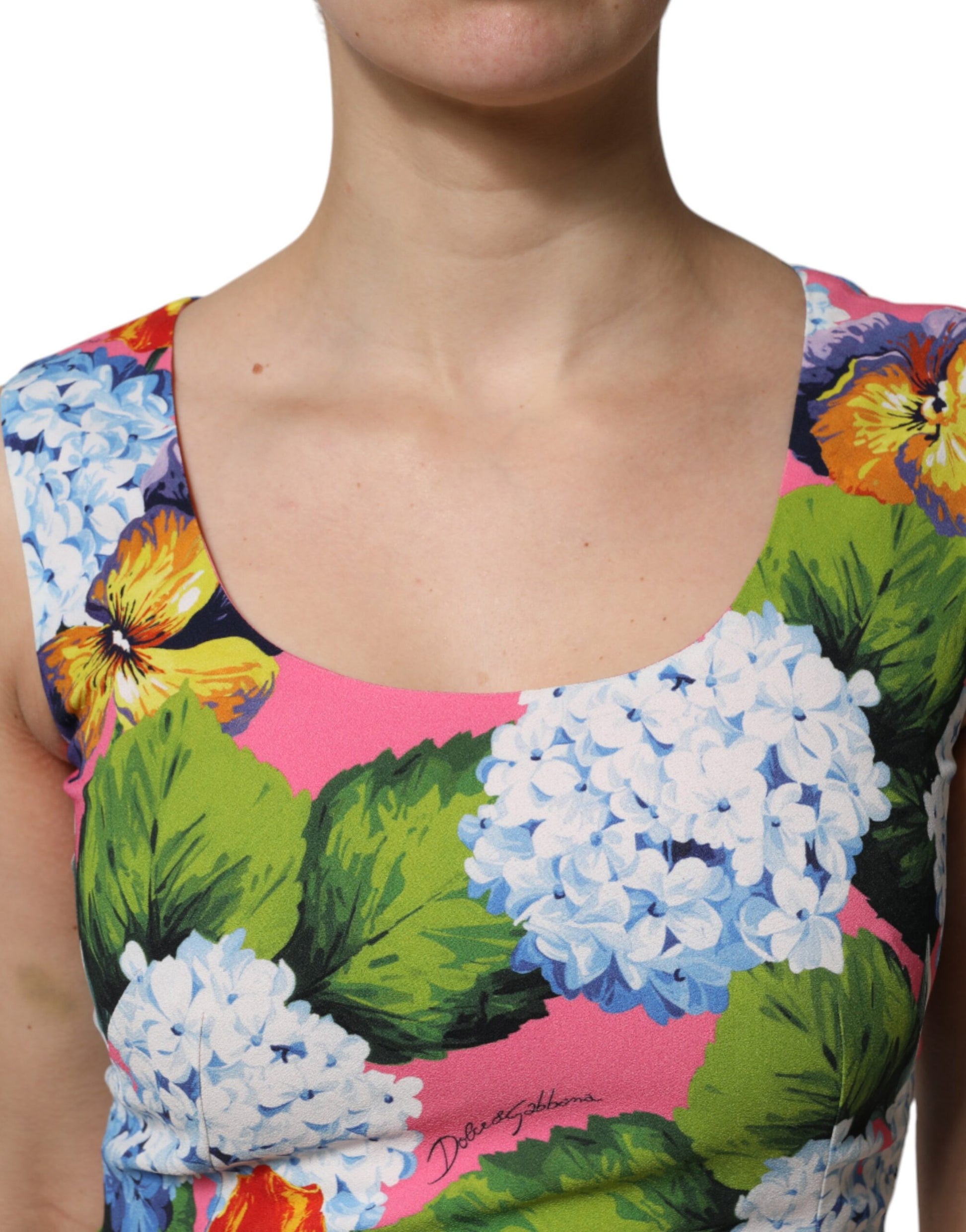 A sleeveless sheath dress with a multicolored floral pattern