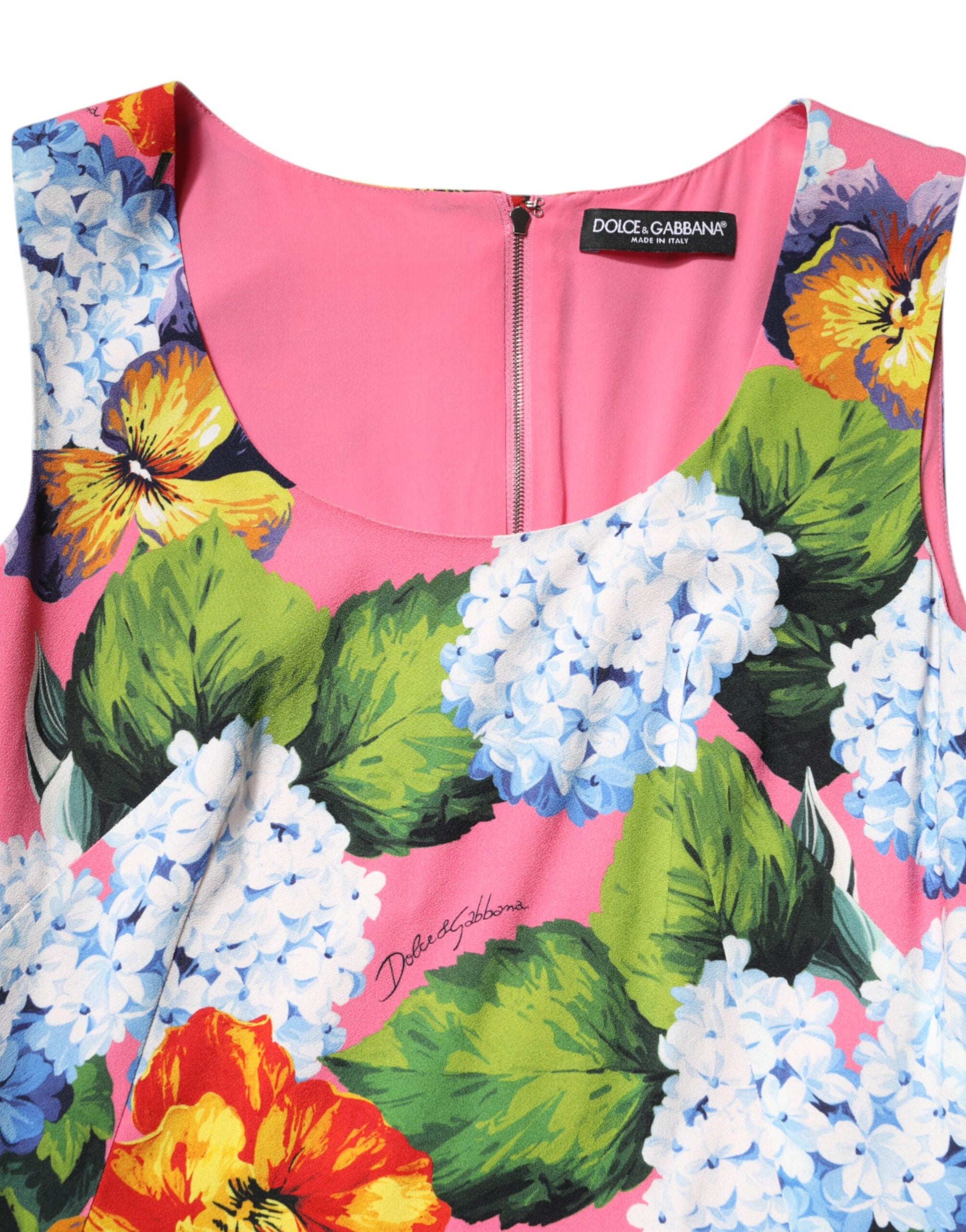 A sleeveless sheath dress with a floral pattern in shades of pink, blue, and yellow
