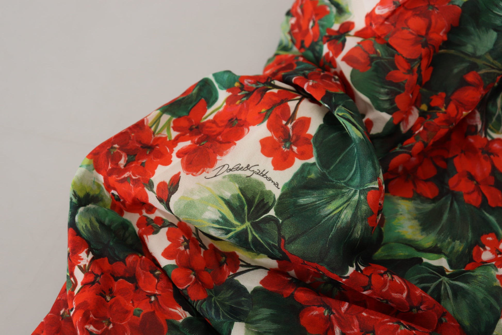 A red, green, and white floral print midi dress with a sheath silhouette