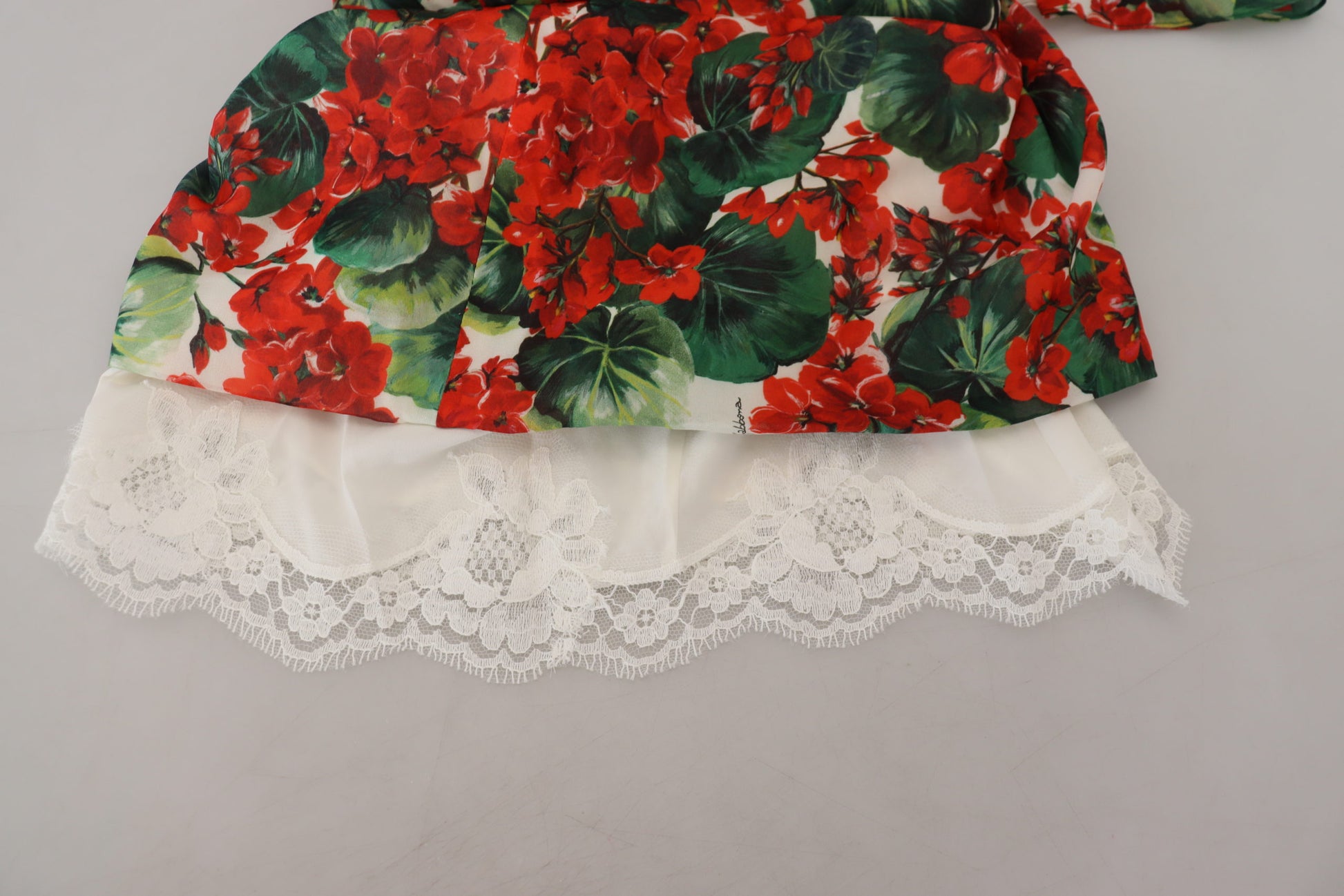 A red, white, and green floral print dress with lace trim