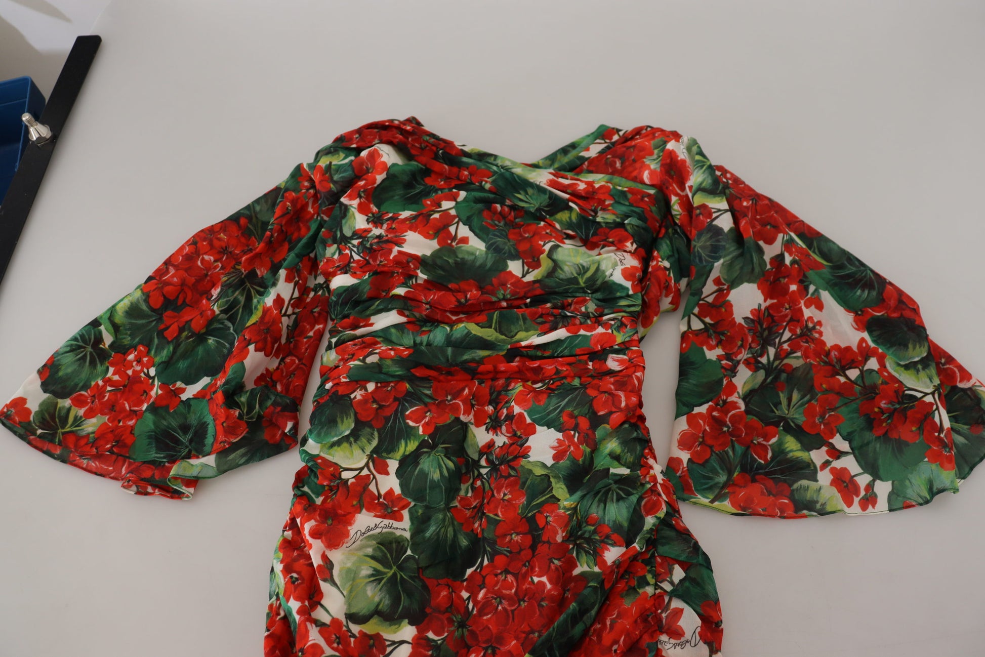 A red, white, and green floral print midi dress with long sleeves