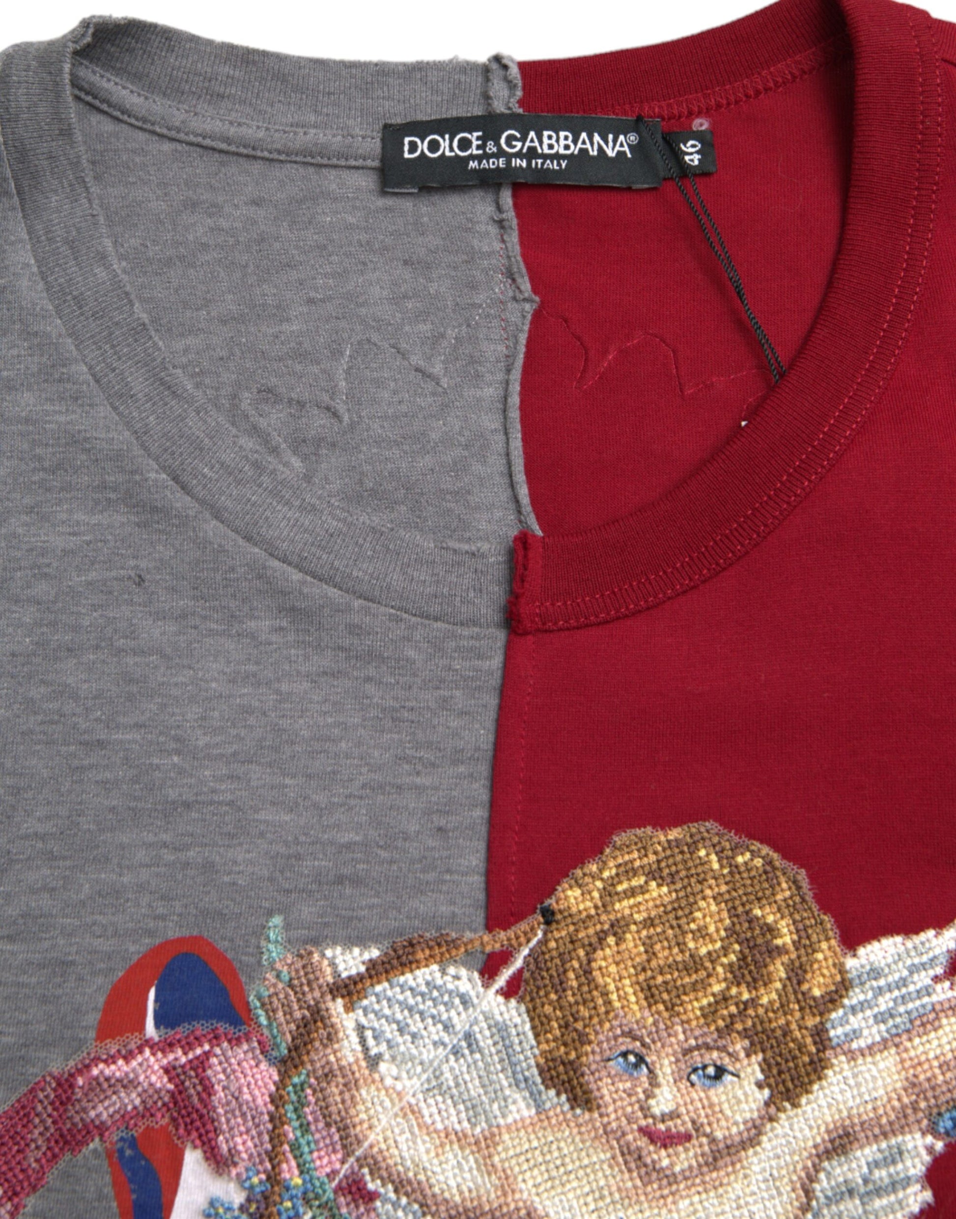 Two shirts on hangers, one gray and one red, with a cross stitched angel design