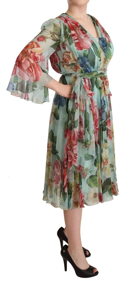 A woman wearing a colorful floral wrap dress with long sleeves