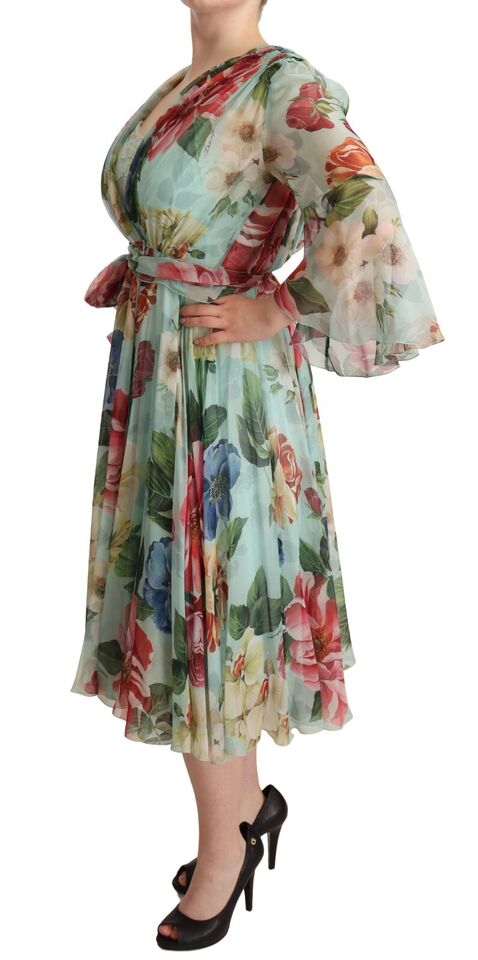 A woman wearing a floral midi dress with ruffled sleeves