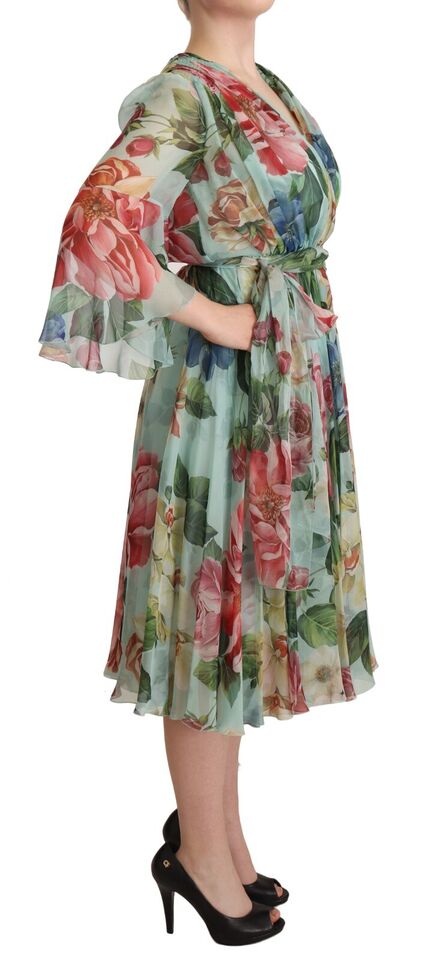 A woman wearing a floral wrap midi dress with green and pink flowers