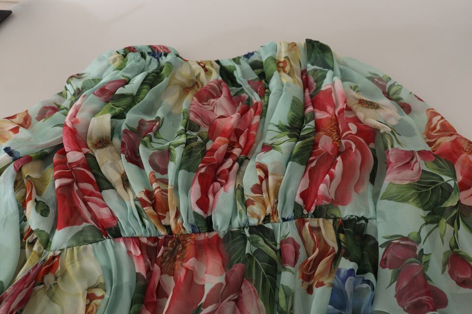 A colorful floral wrap dress with a green base and red, yellow, and blue flowers