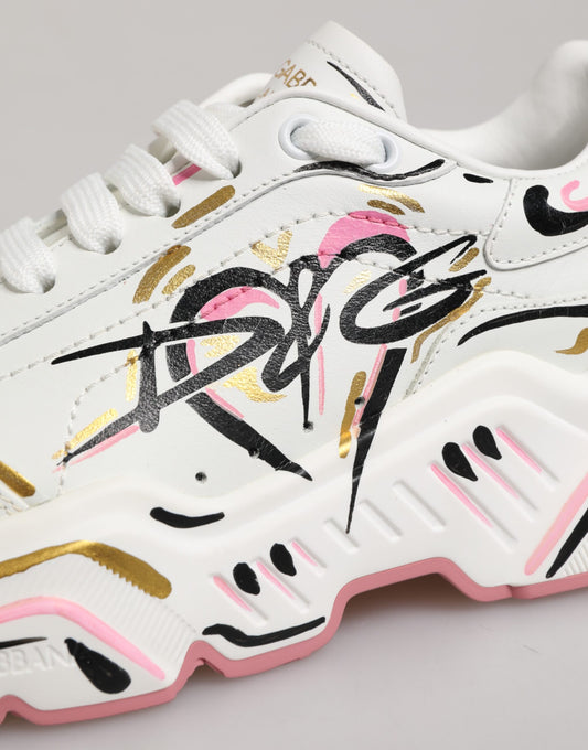White sneakers with multicolored hand-painted design, featuring gold and pink accents