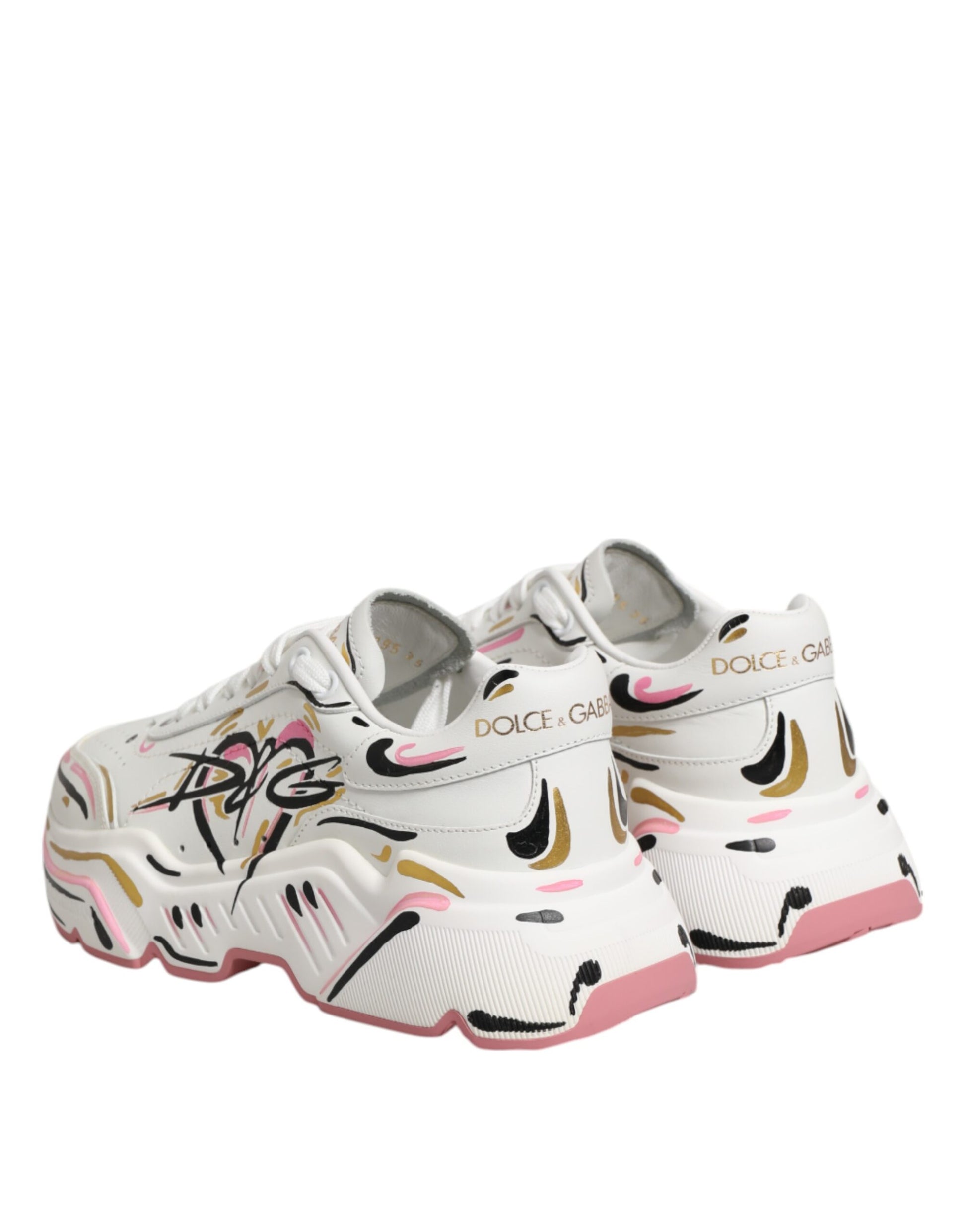 A pair of multicolored hand-painted sneakers with a pink and gold design