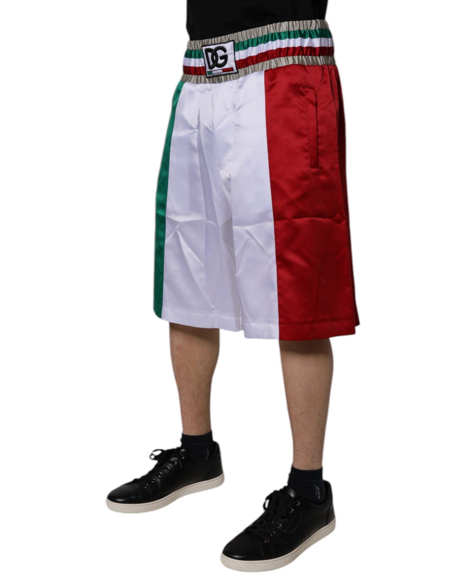 A pair of shorts with a multicolored design featuring the Italian flag colors. They are made of polyester and