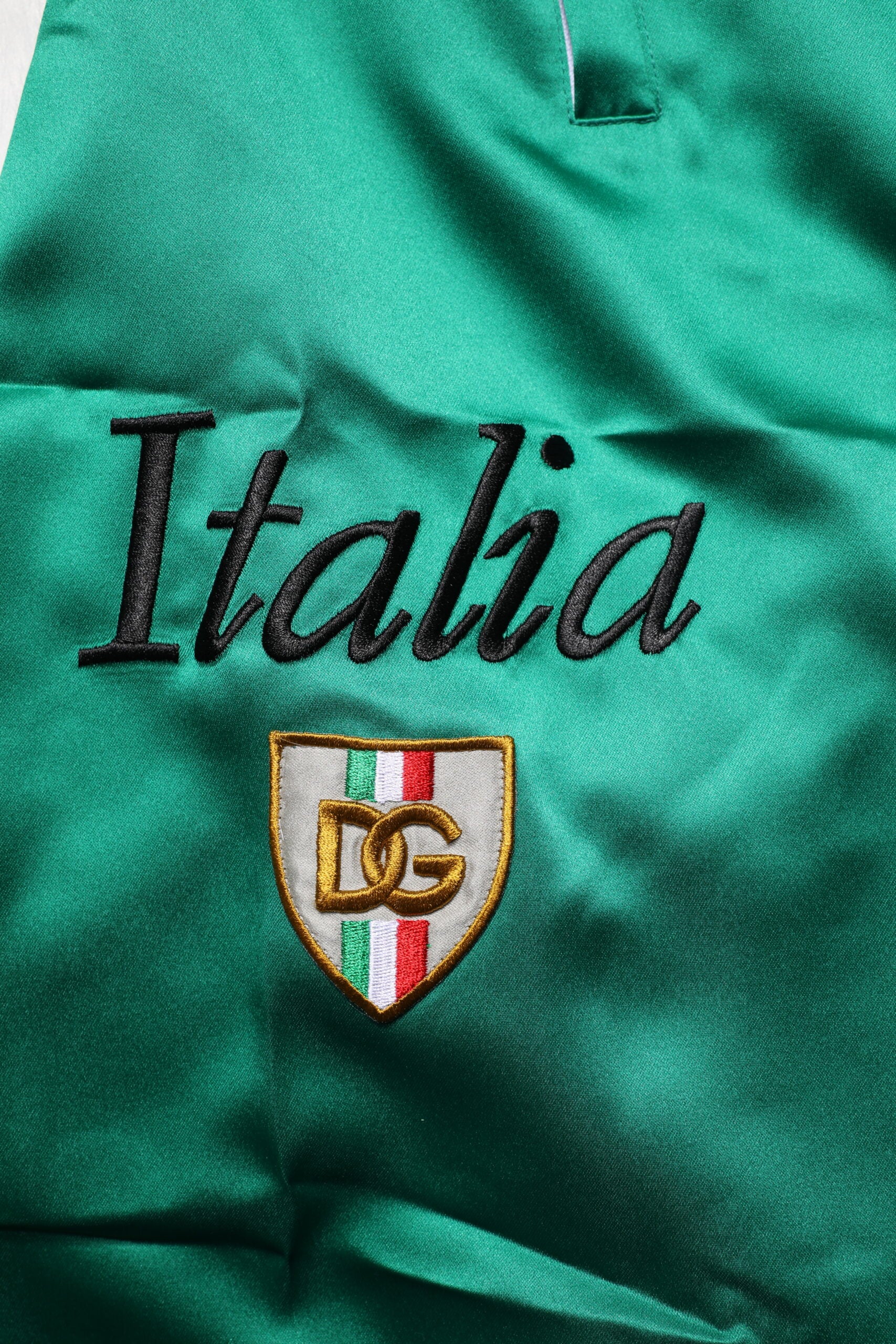 Green polyester shorts with Italy embroidered on front, featuring a multicolored design and the D&G logo
