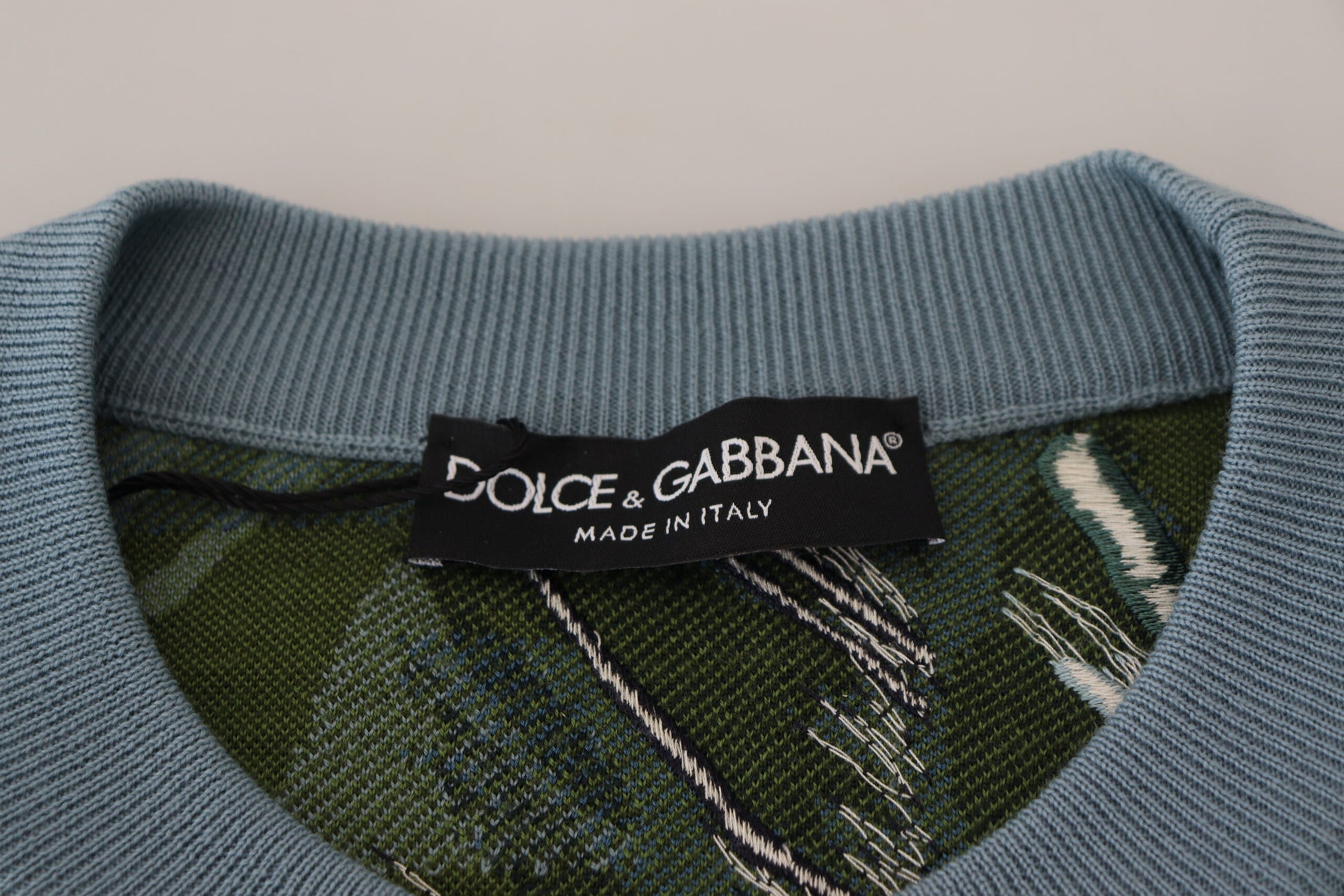 Blue sweater with green patterned sleeves