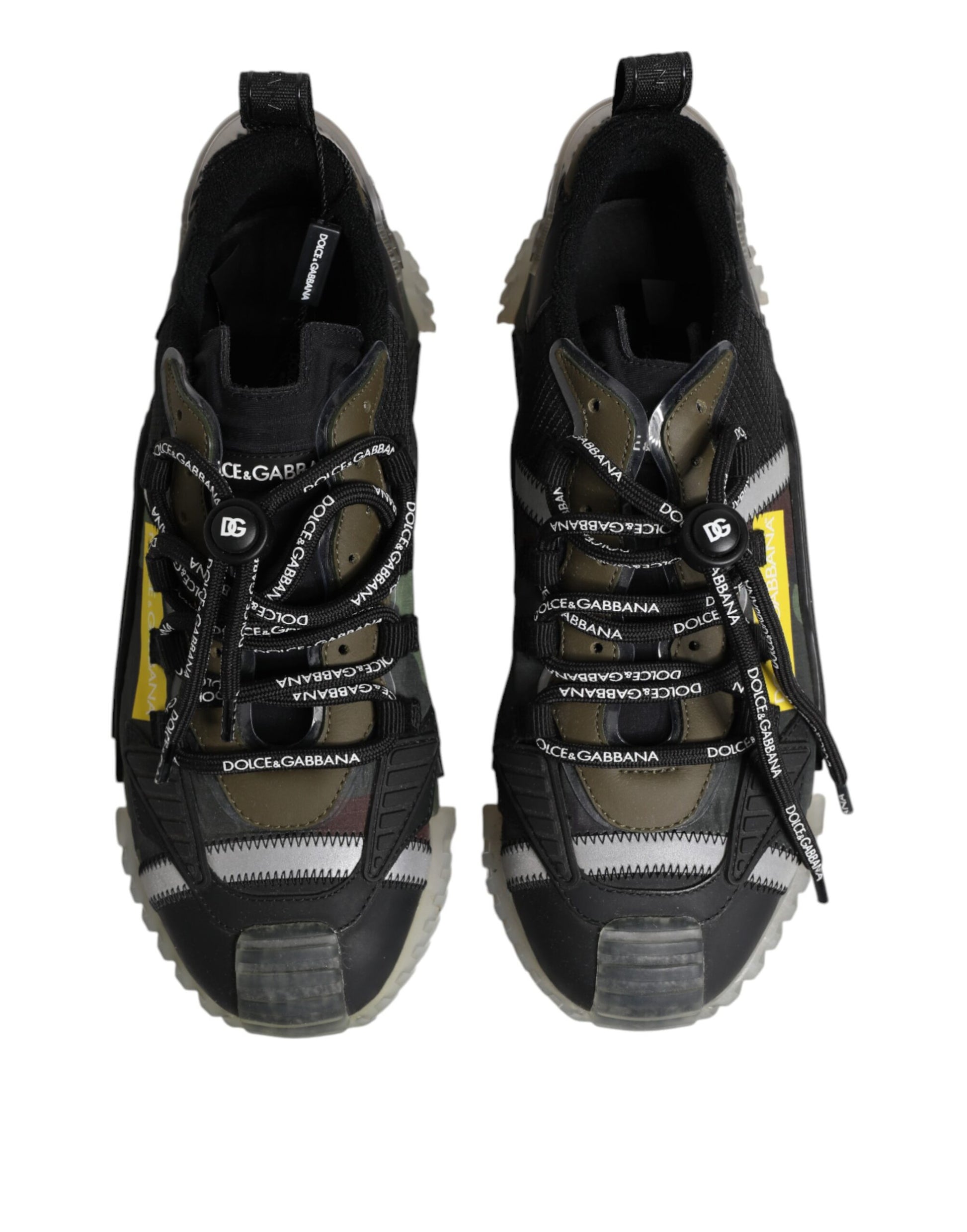 Pair of black sneakers with white laces and yellow accents