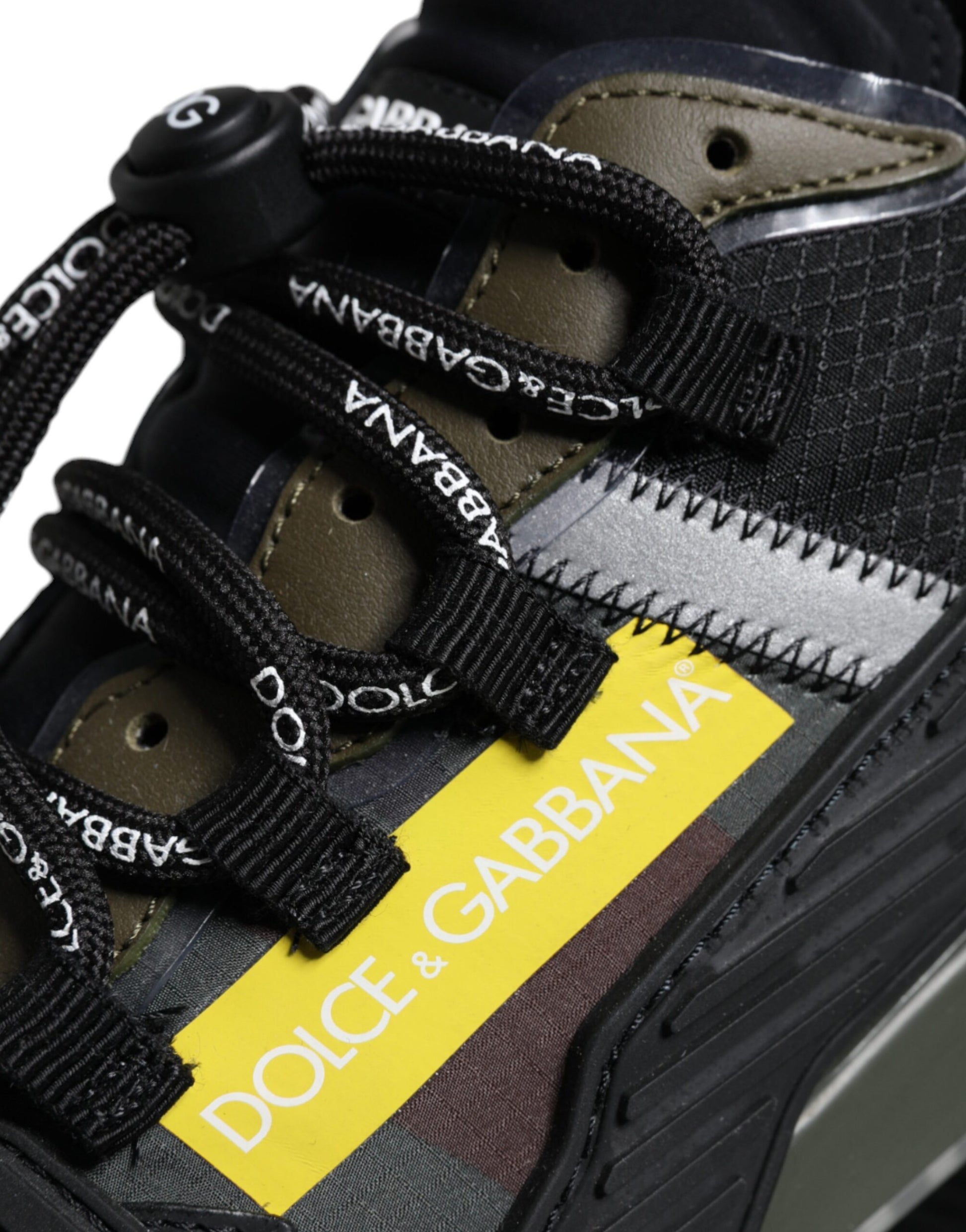 A pair of multicolored lace-up sneakers with a yellow label on the side