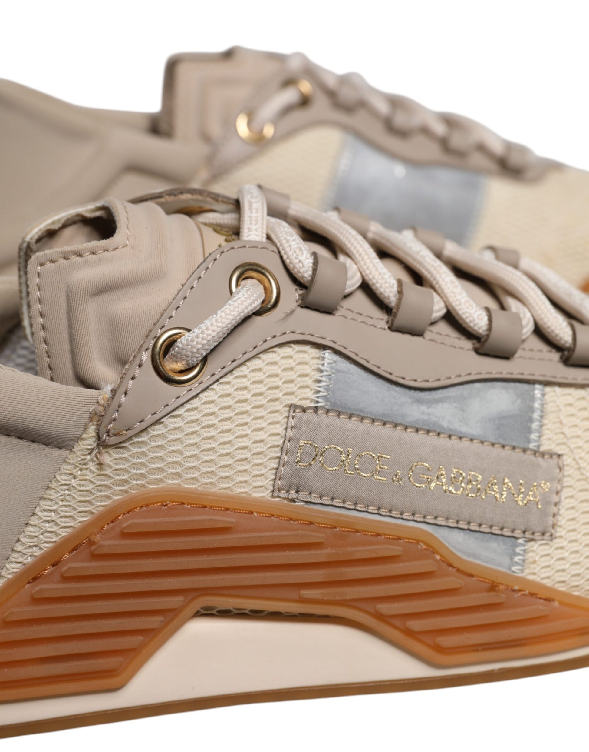 Tan sneakers with laces, brand logo on side