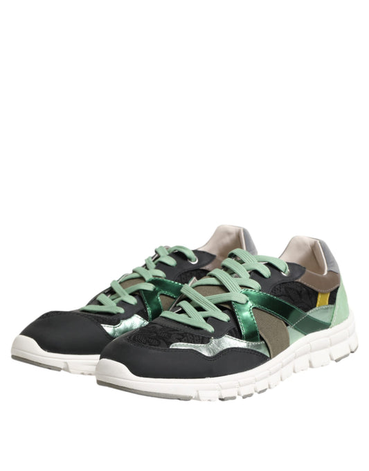 Pair of black sneakers with green laces and a white sole