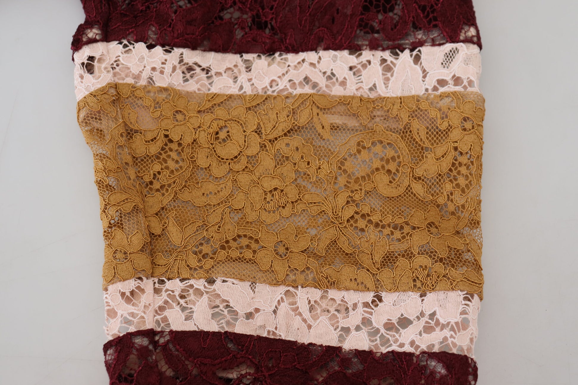 Brown lace fabric with red and pink accents