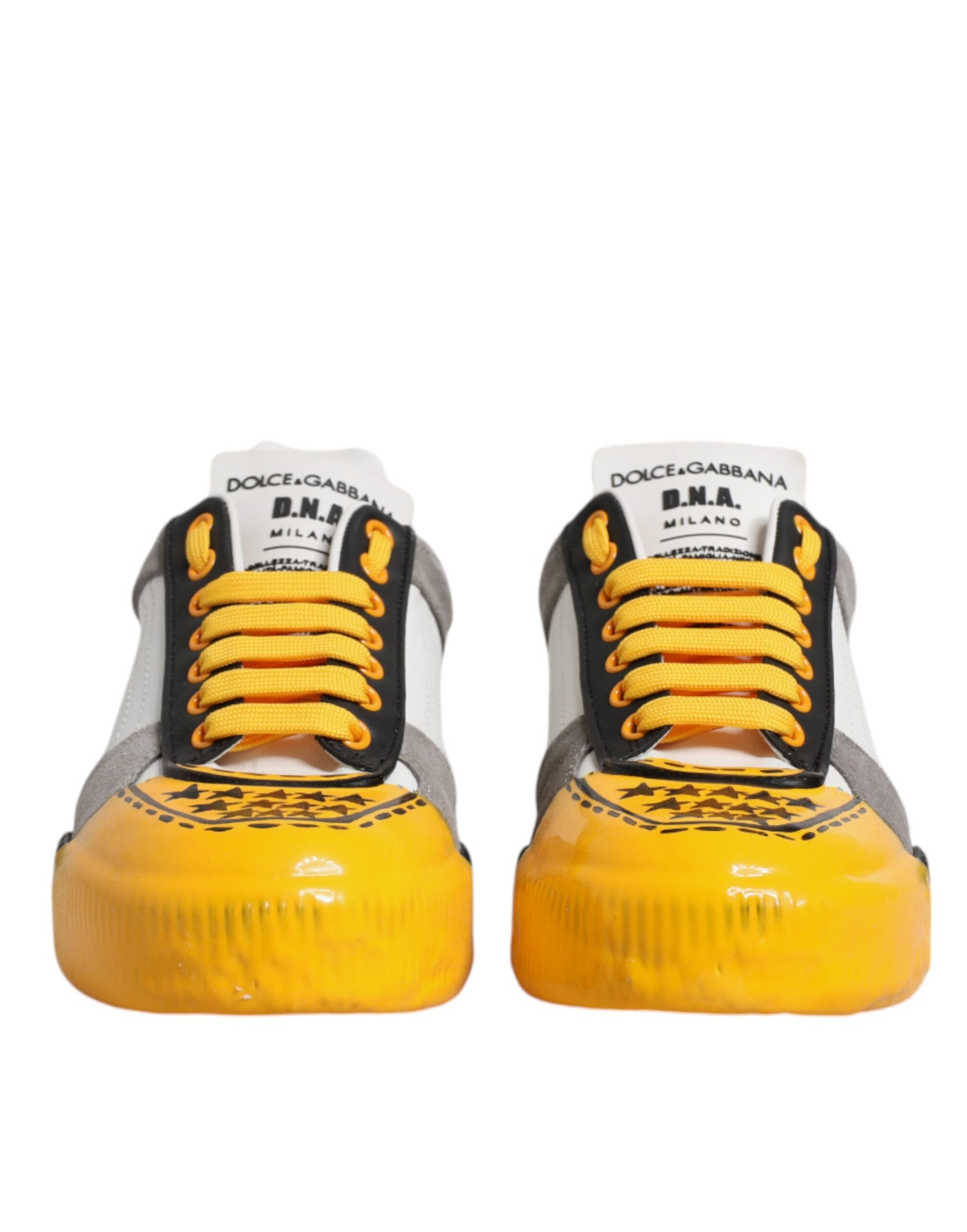 Pair of yellow and gray sneakers with black laces and white soles