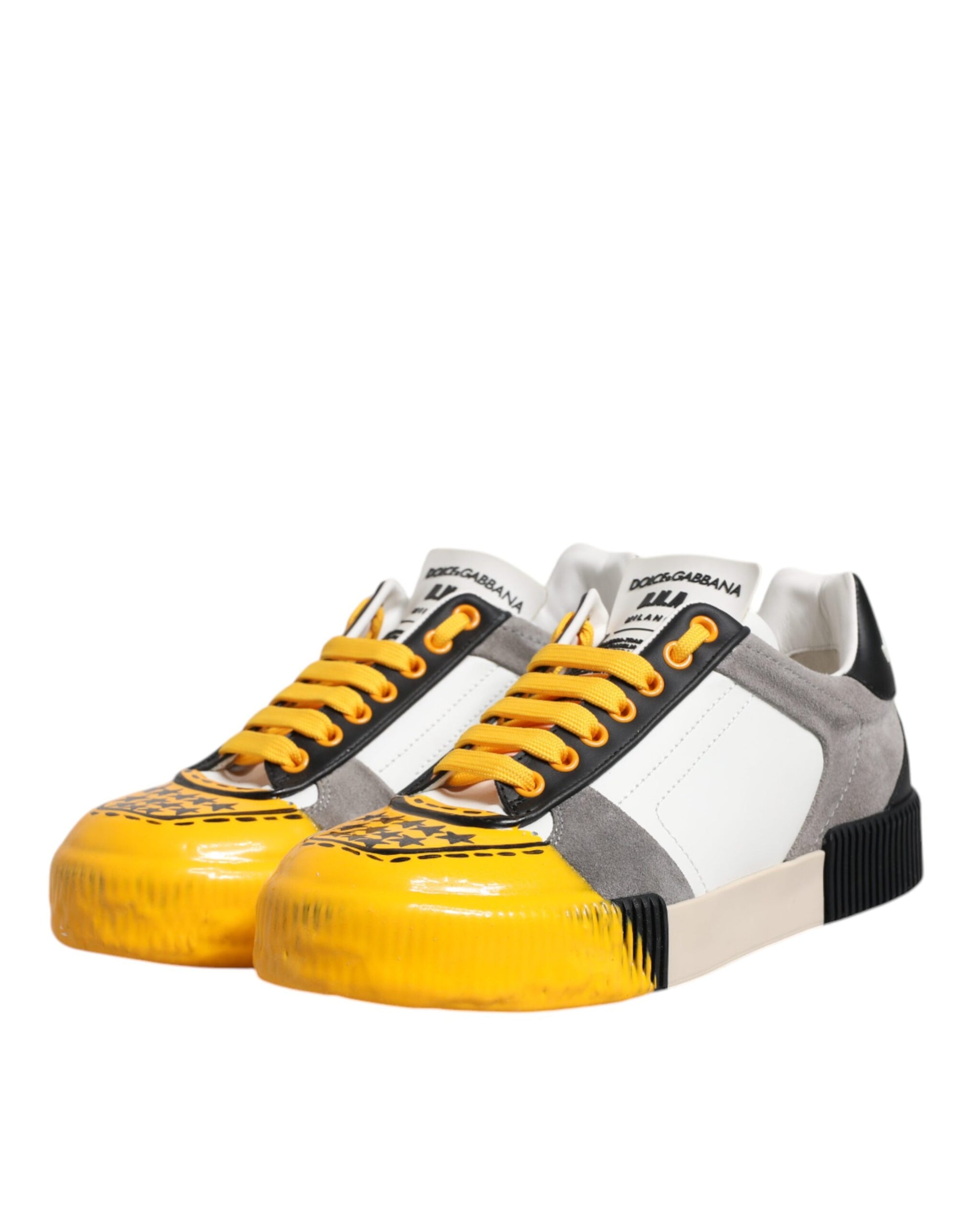 Pair of yellow and white sneakers with black laces