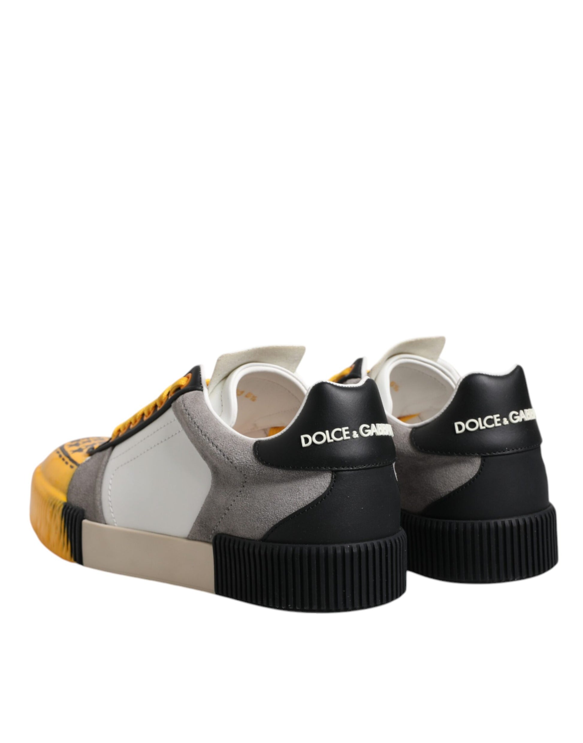 Pair of sneakers with black and white laces, yellow accents, and a chunky sole design