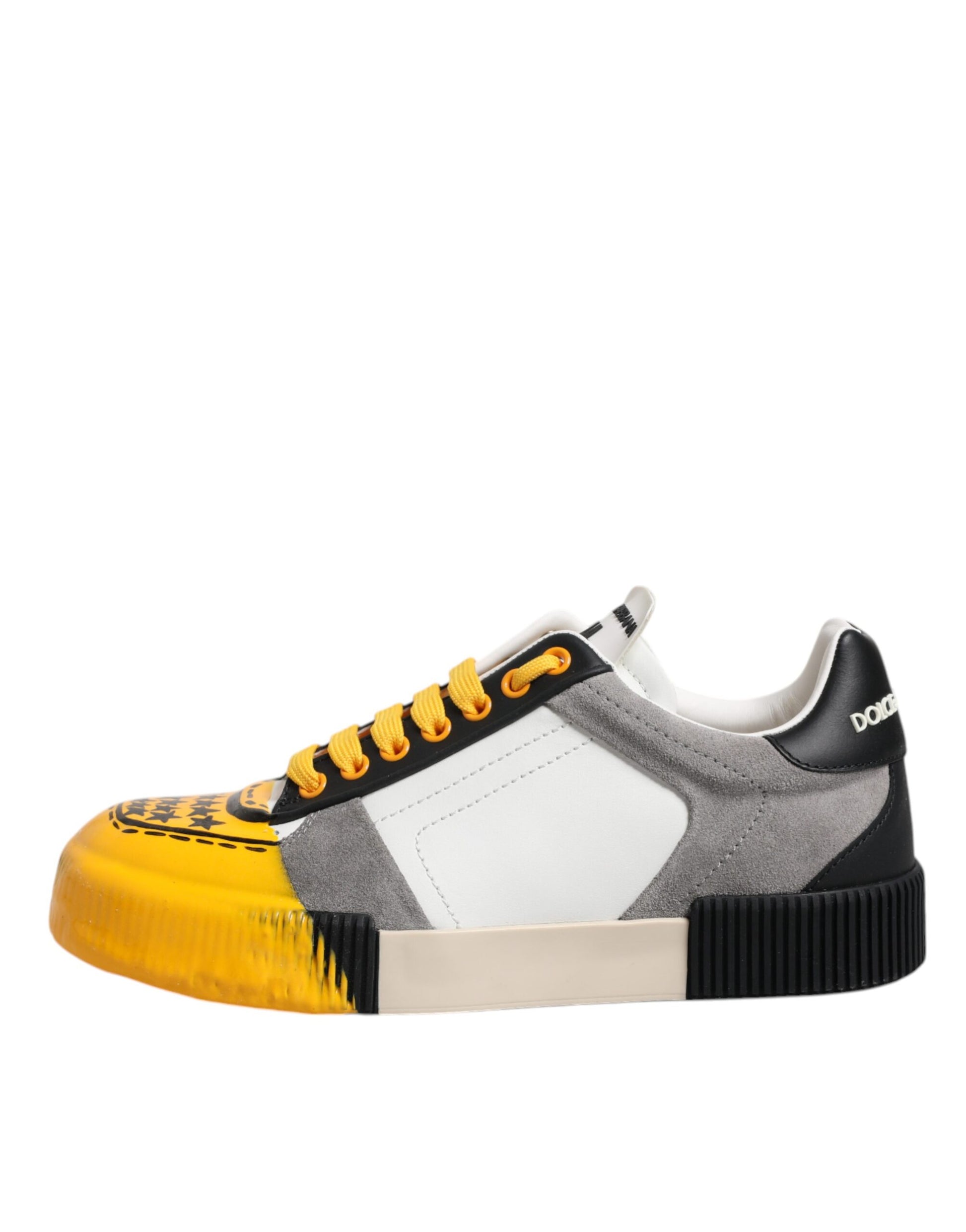 A single sneaker with a colorful design featuring yellow, black, and white elements. It has a high top with a lace closur