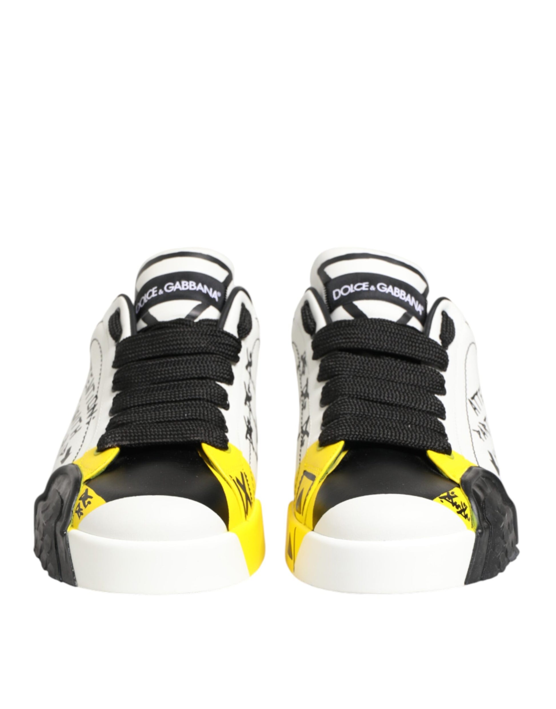 Pair of black and yellow sneakers with white soles