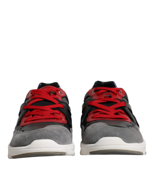 Pair of sneakers with red laces and black soles