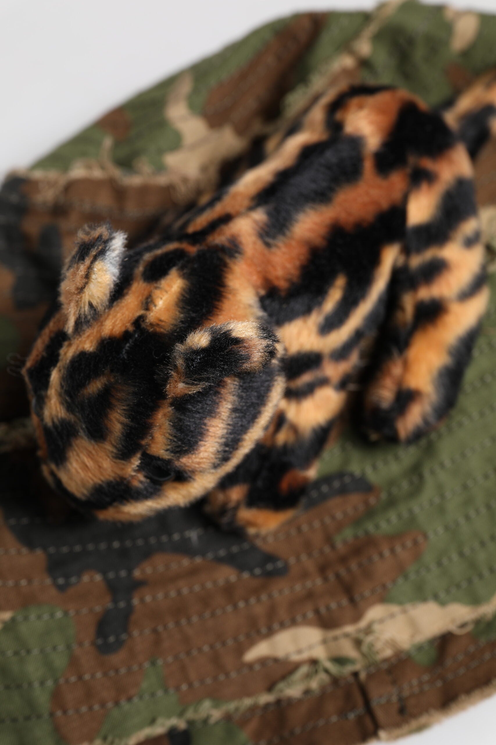 Stuffed animal on camouflage fabric