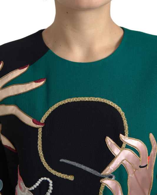 Green, black, and pink dress with embroidered face design