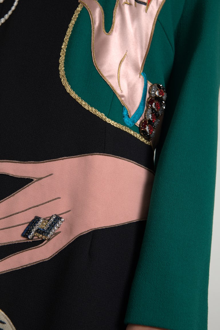 Green, pink, and white long sleeve dress with embroidered hand
