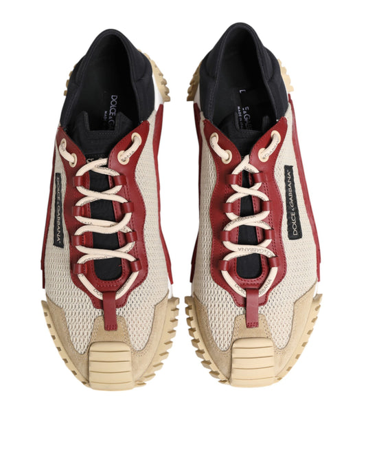 Pair of men's sneakers with red and beige laces, featuring a textured upper and chunky soles
