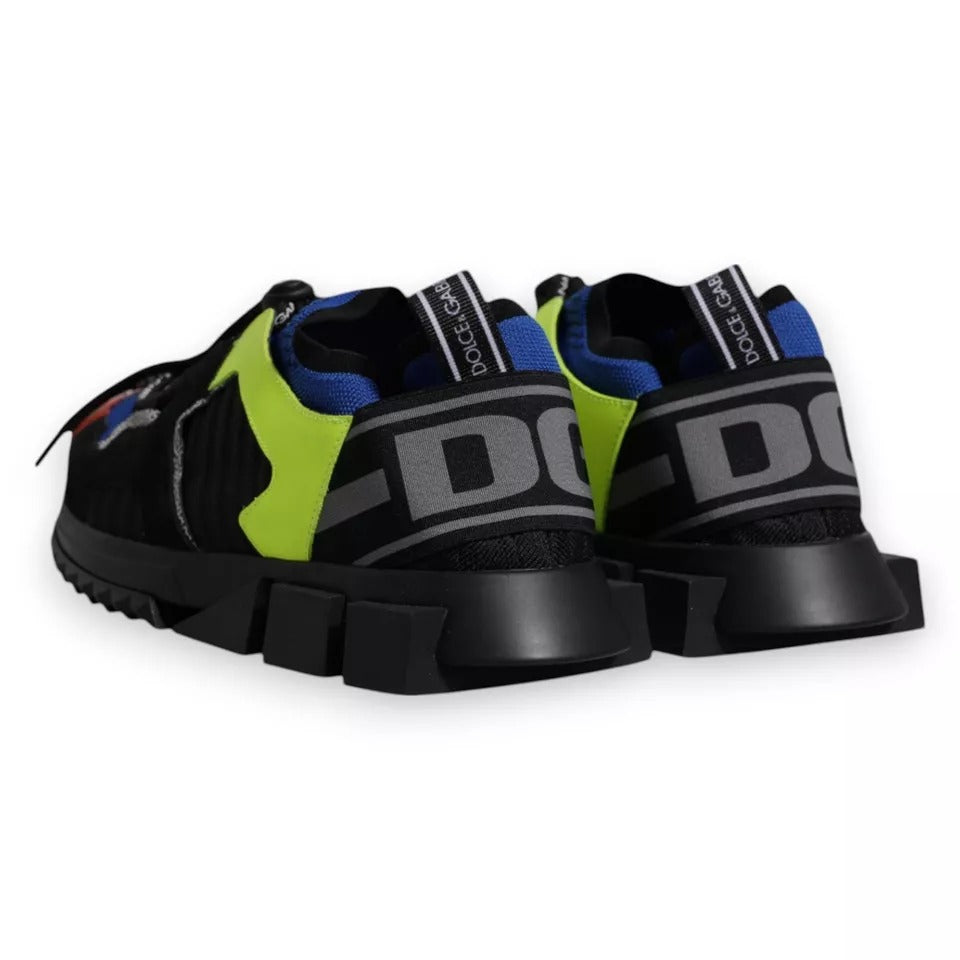 Pair of black and green athletic shoes with white lettering