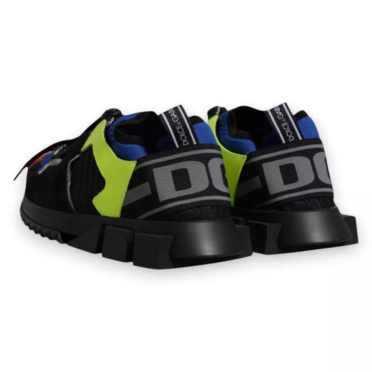 Pair of black and green athletic shoes with white lettering