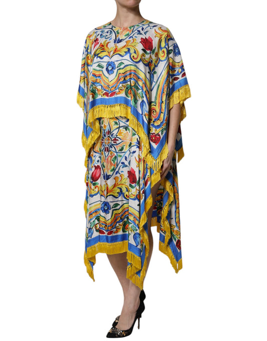 A woman wearing a colorful, long-sleeved maxi dress with intricate patterns and embellishments