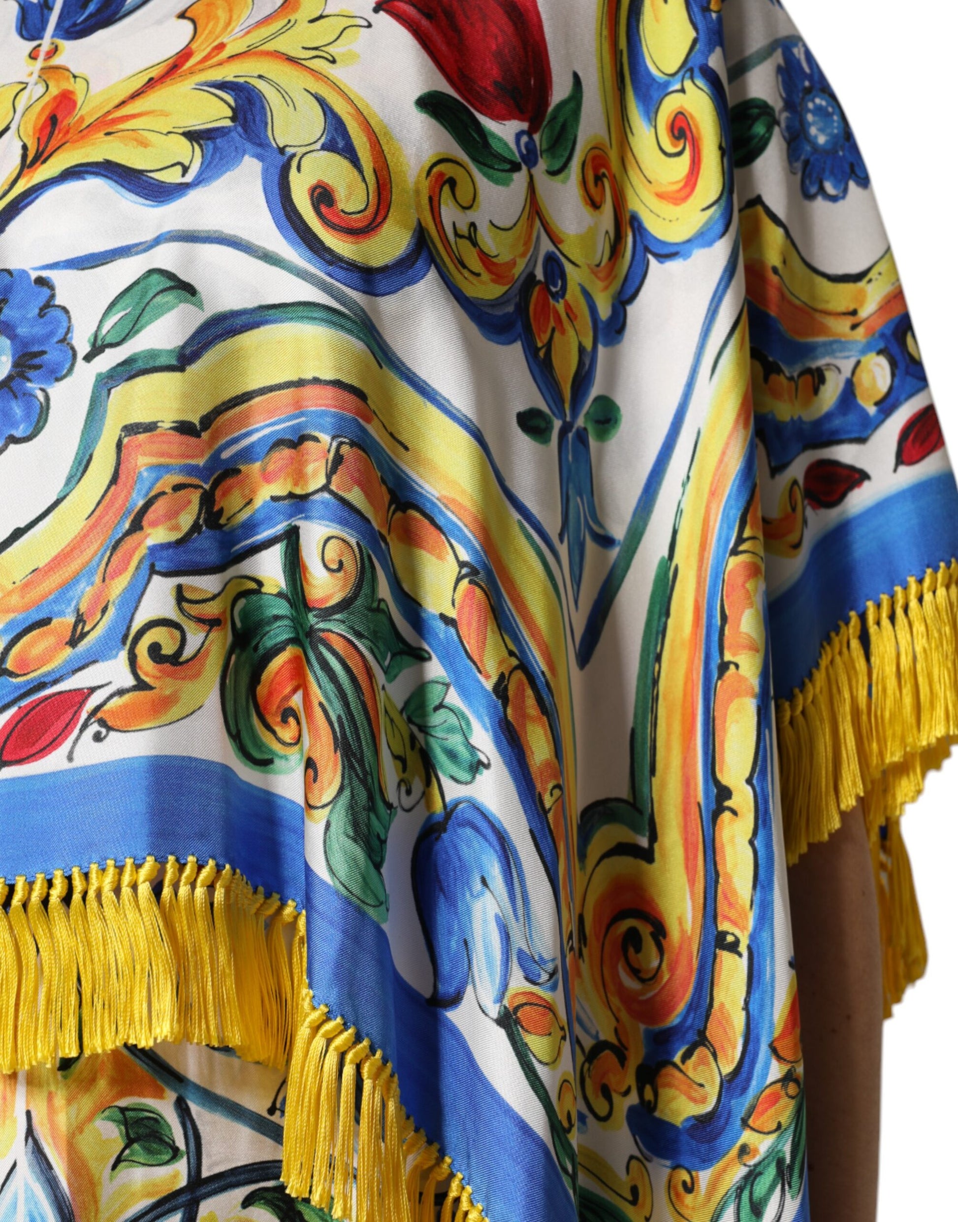 A colorful, patterned kaftan dress with fringe details